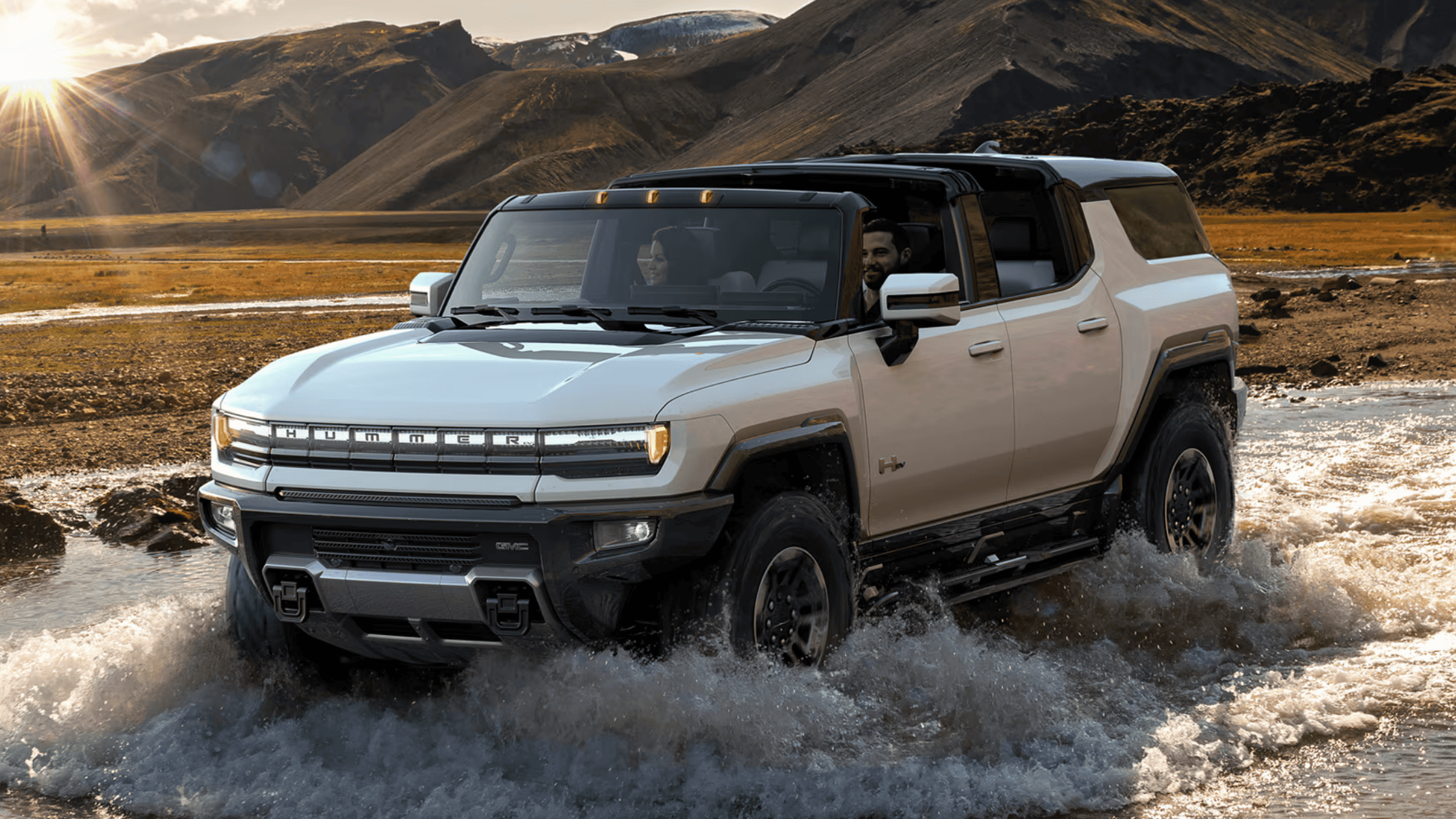 2025 GMC Hummer EV SUV driving through water near West Jefferson with CrabWalk engaged