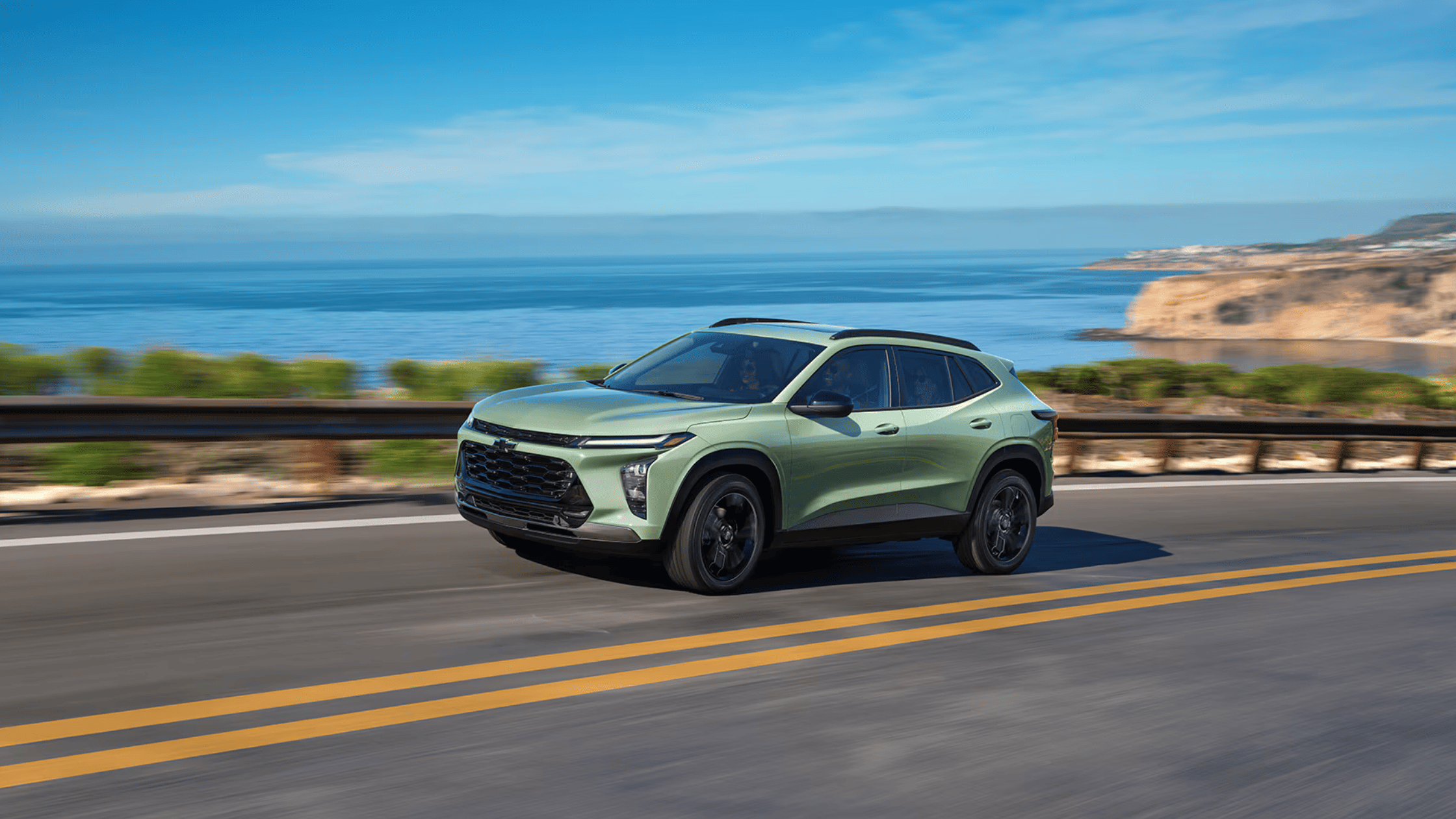 2025 Chevrolet Trax in Cacti Green cruising coastal roads, highlighting sleek redesign near West Jefferson, NC.