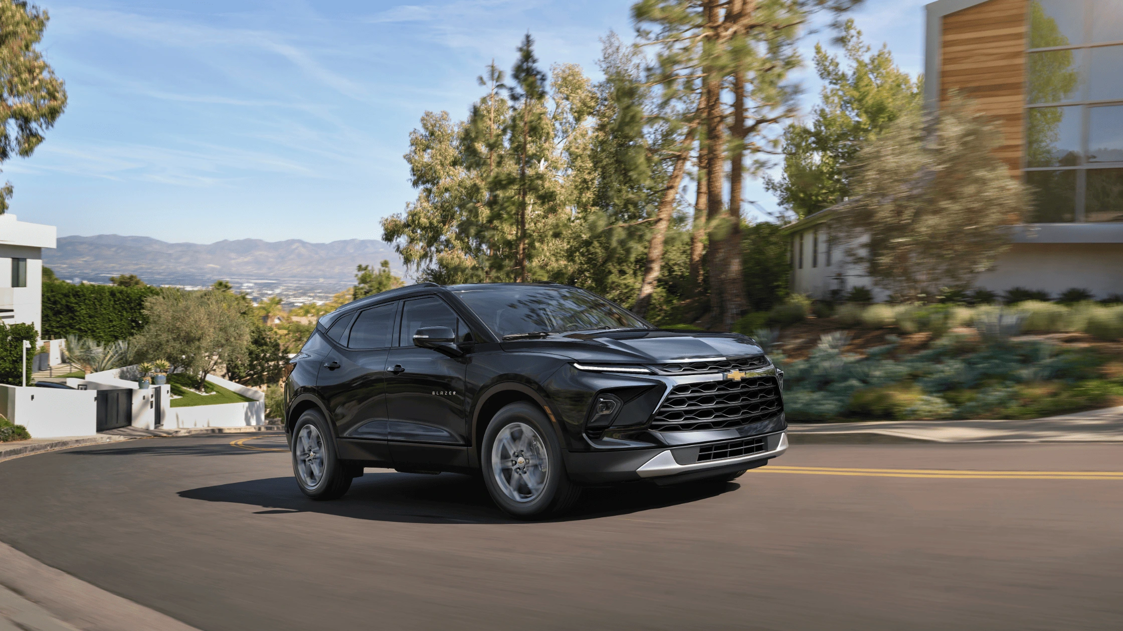2025 Chevrolet Blazer turning through a scenic residential street in Morganton, NC.