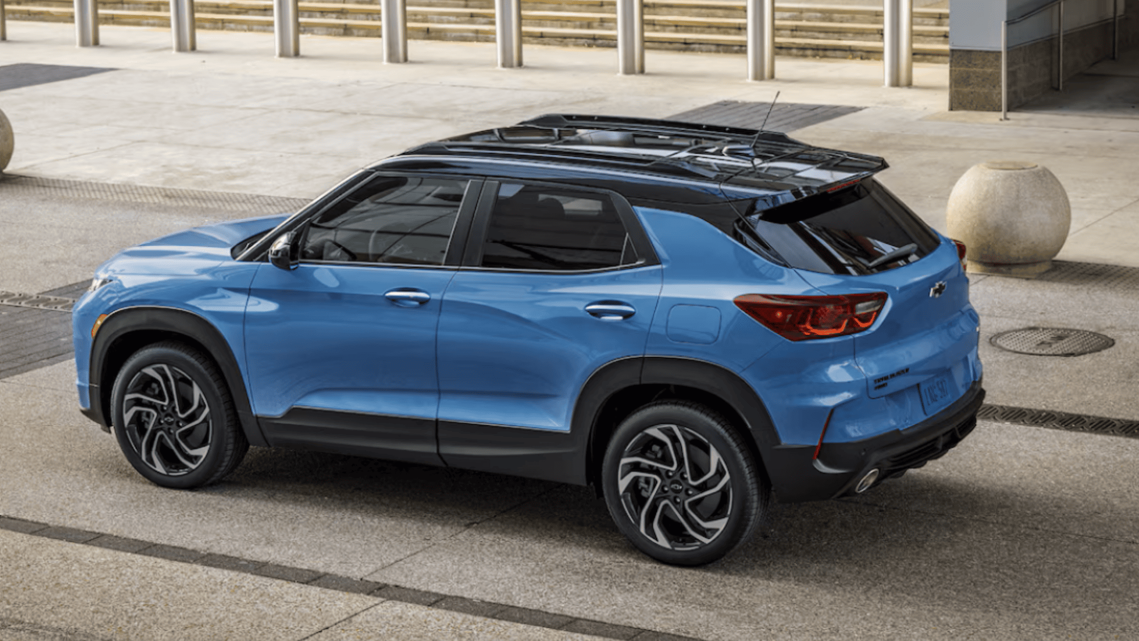 2025 Chevrolet Trailblazer in blue parked in an urban setting near Morganton, NC, showcasing its compact crossover size and turbo engine efficiency.