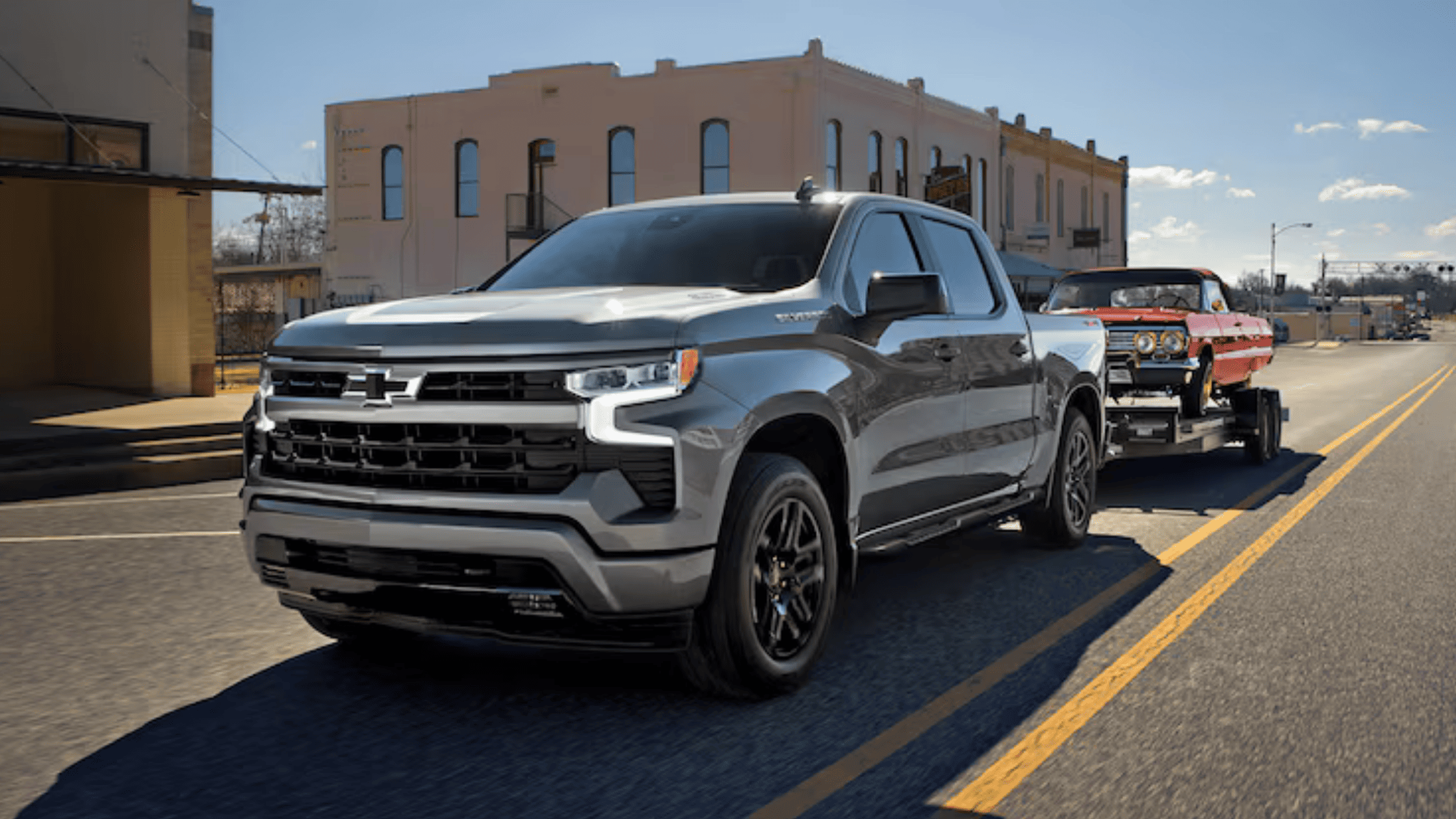 2026 Chevrolet Silverado towing trailer on the road near Morganton NC showing strong towing capability