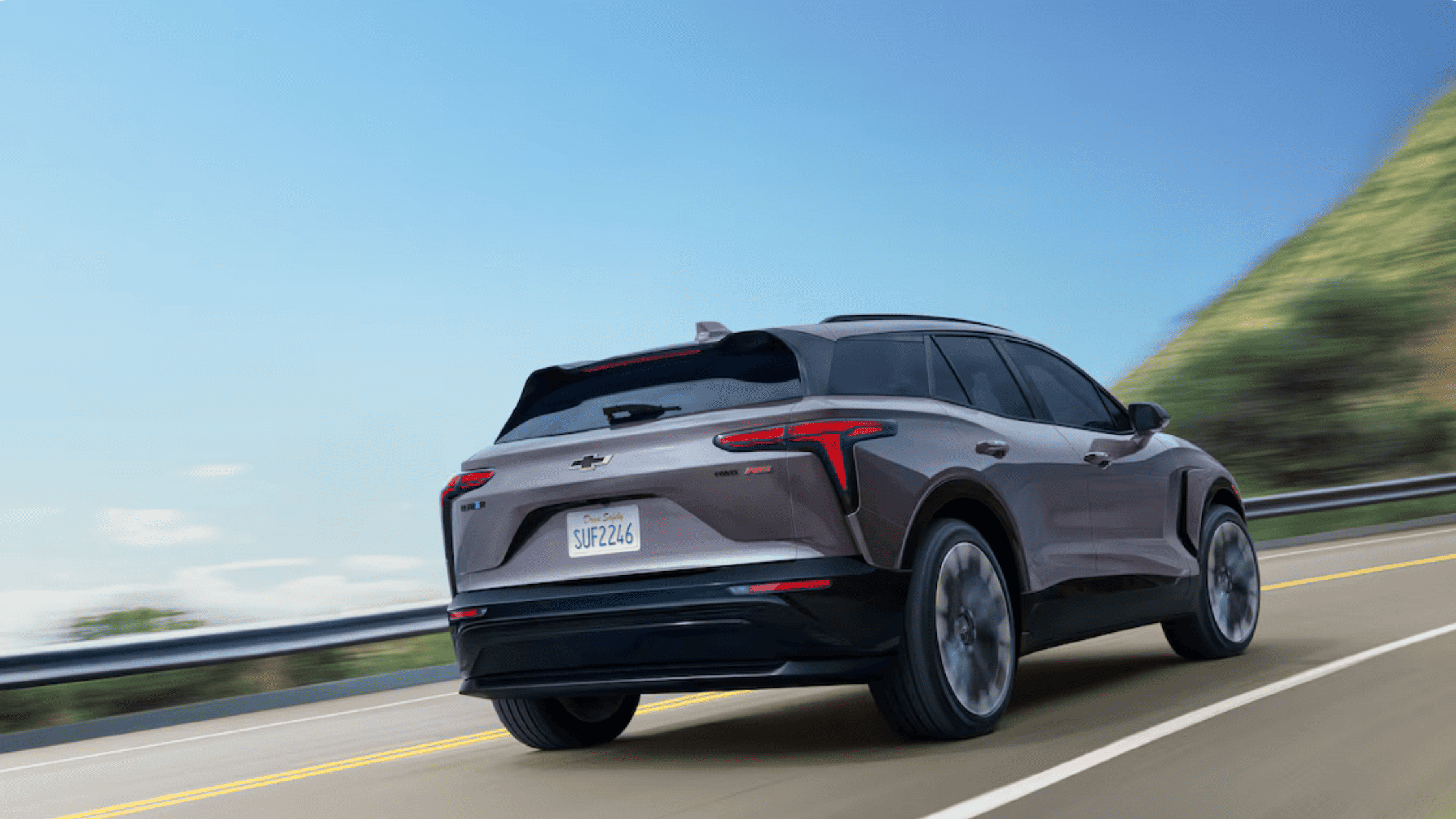 2026 Chevrolet Blazer EV driving on the highway, highlighting its electric SUV styling for Morganton NC commuters.