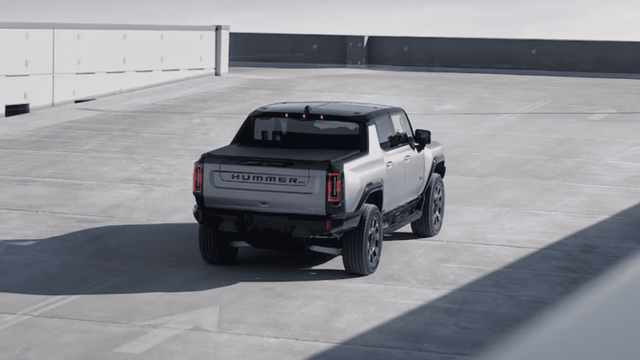 2026 GMC Hummer EV pickup truck maneuvering in CrabWalk mode on a rooftop parking area near Morganton NC.