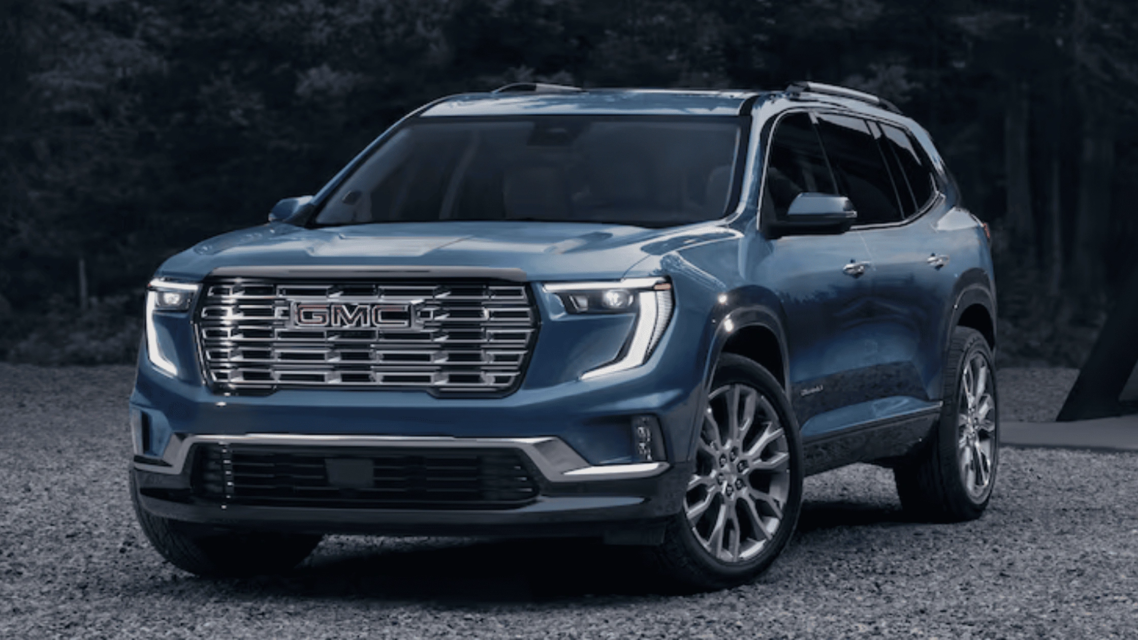 Style and Seating Make the 2026 GMC Acadia Denali a Smart Pick for Morganton NC Families – blue GMC Acadia Denali SUV parked on gravel at dusk, highlighting premium styling and spacious family seating.