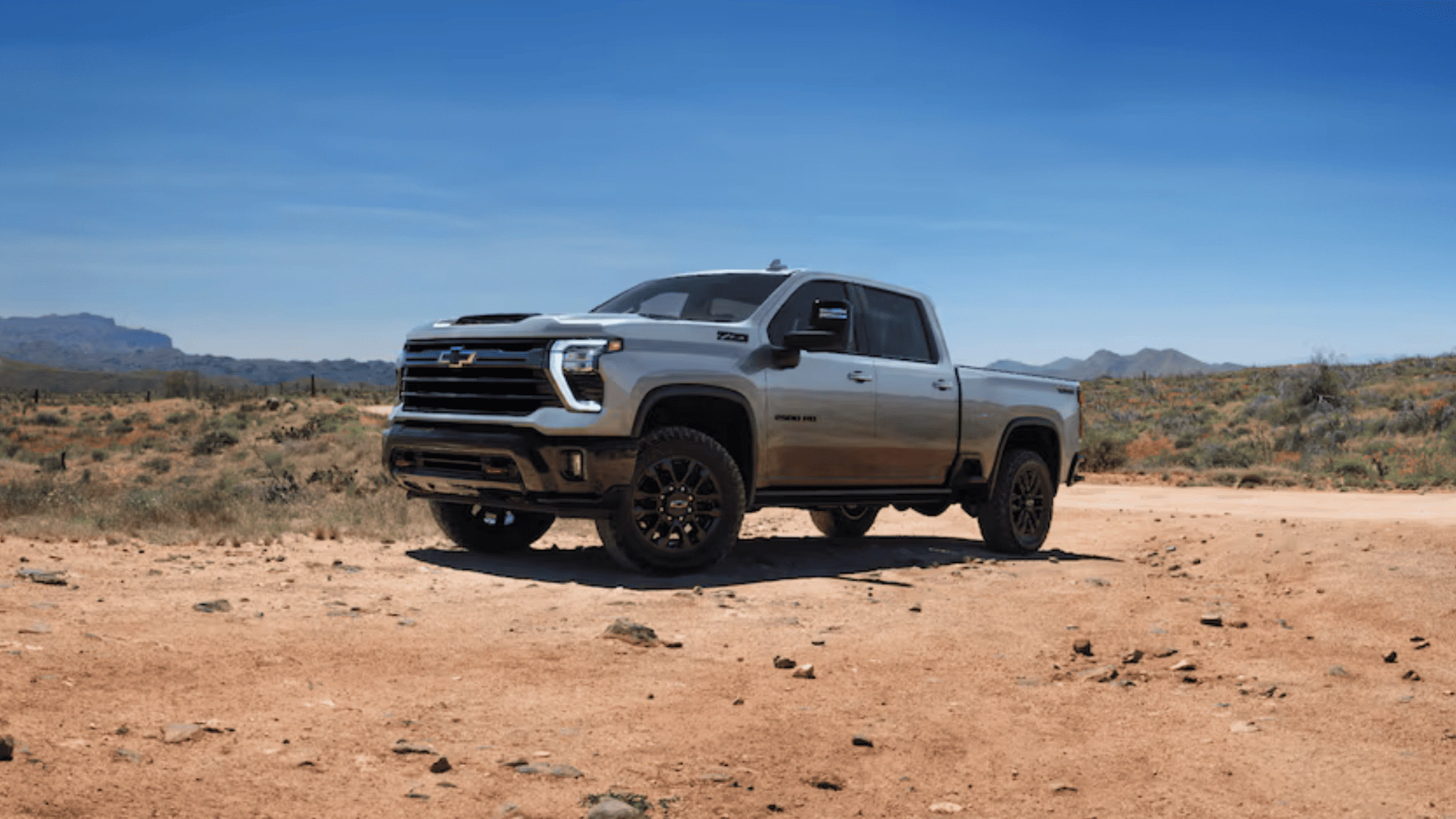 What Morganton NC Contractors Should Know About the 2026 Chevrolet Silverado HD – silver Chevrolet Silverado HD pickup truck parked on a desert dirt road, highlighting heavy-duty capability and work-ready performance.