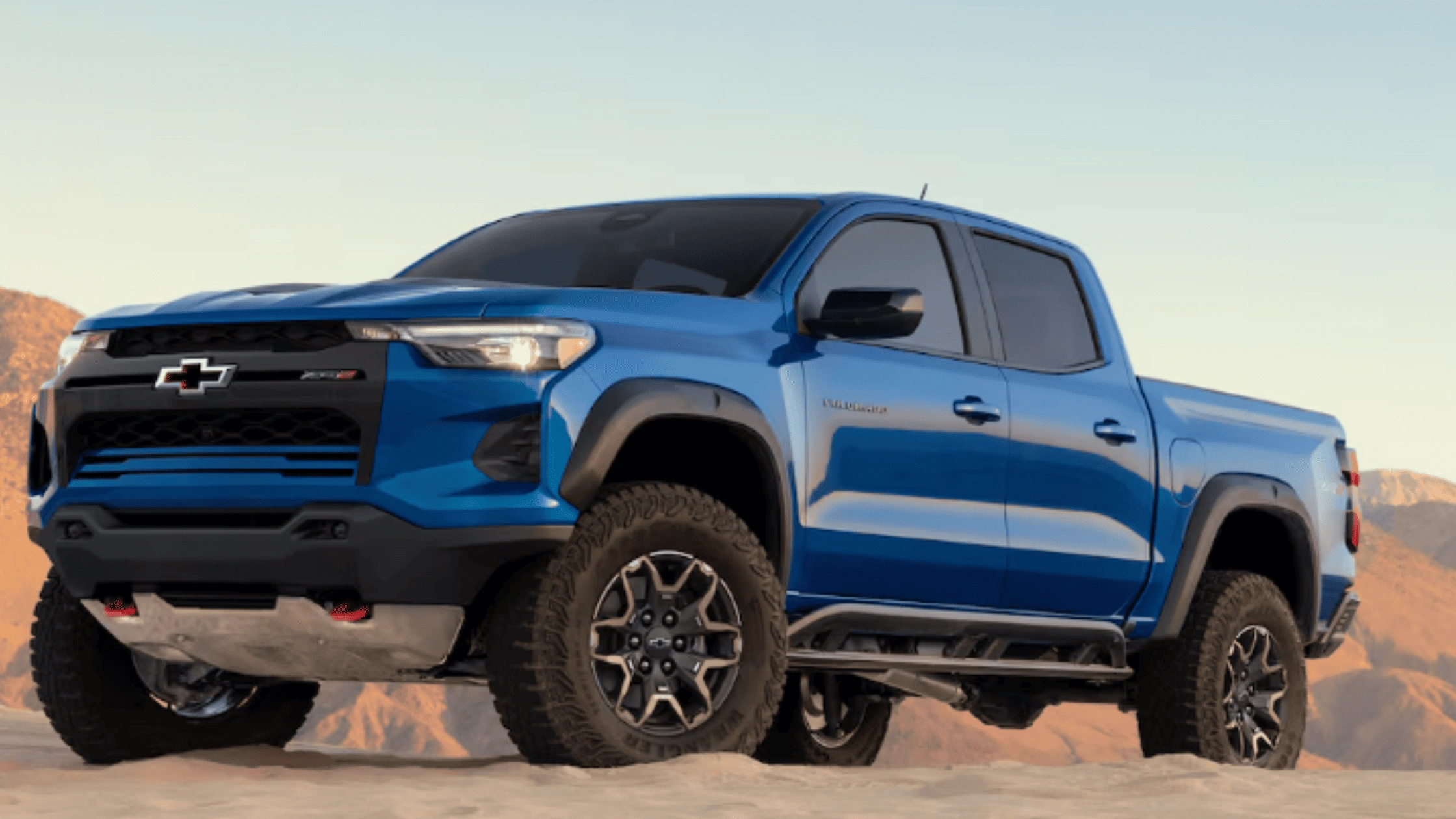 Blue 2026 Chevrolet Colorado pickup truck positioned on desert terrain, built for winter mountain roads near Morganton, NC.