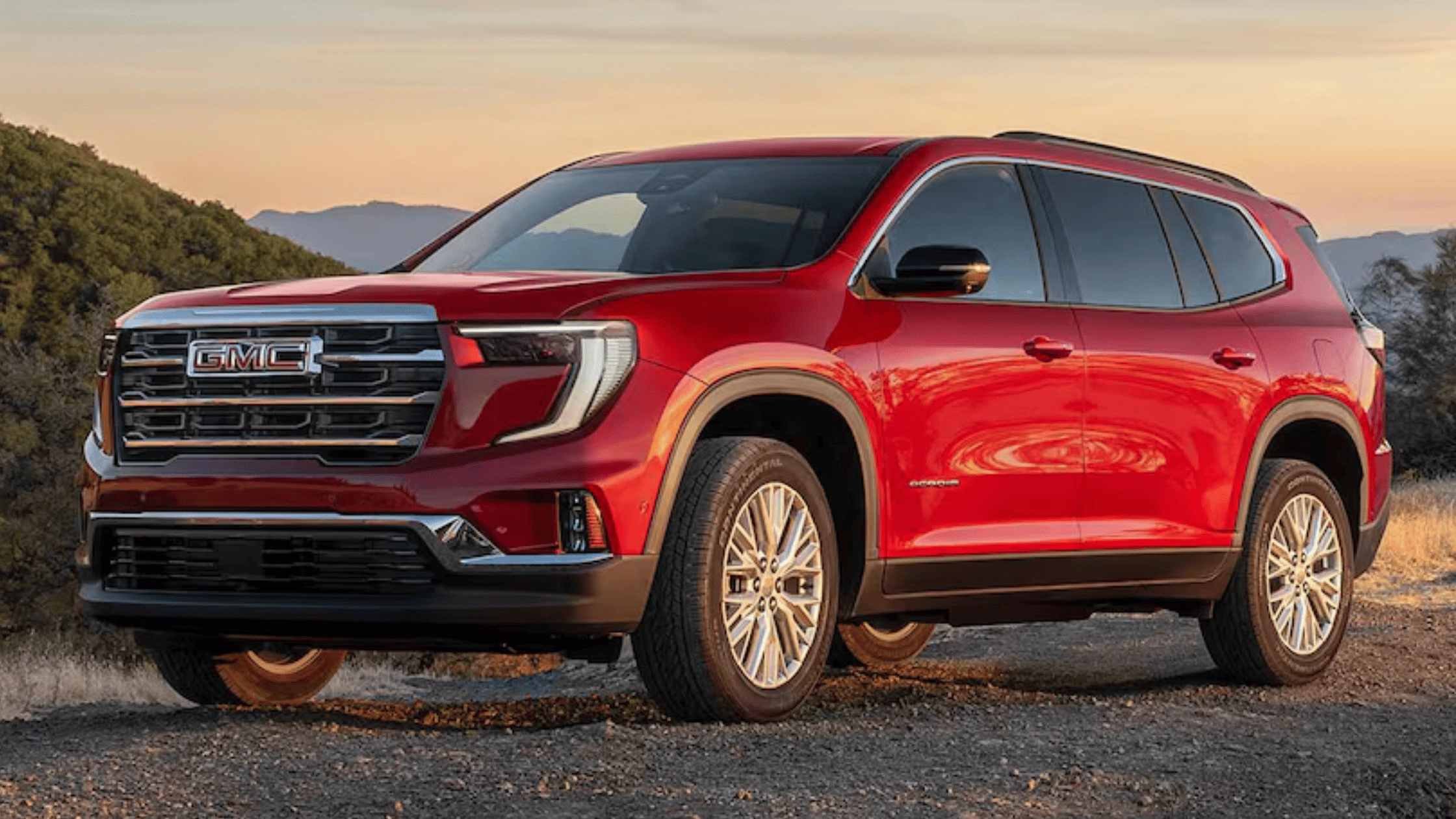Red 2026 GMC Acadia SUV parked on a scenic overlook, showcasing spacious interior and family SUV comfort near Boone, NC.