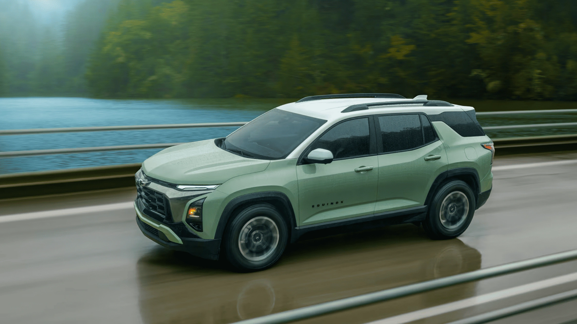 2026 Chevrolet Equinox SUV driving along a wet road beside a river, highlighting smooth ride and versatility near Boone, NC.