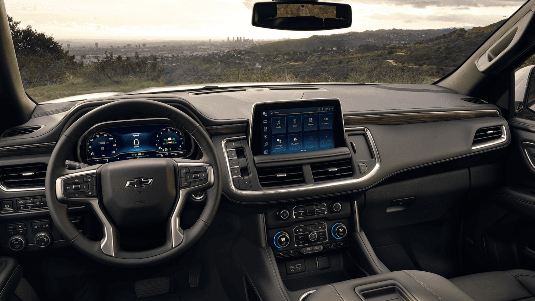 Interior of Chevrolet Tahoe showing digital cluster and infotainment screen.