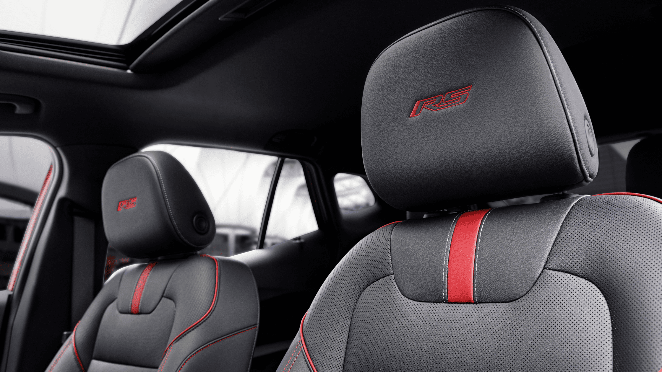Close-up of RS-embroidered headrests and red-accented seats in 2025 Chevrolet Trax RS