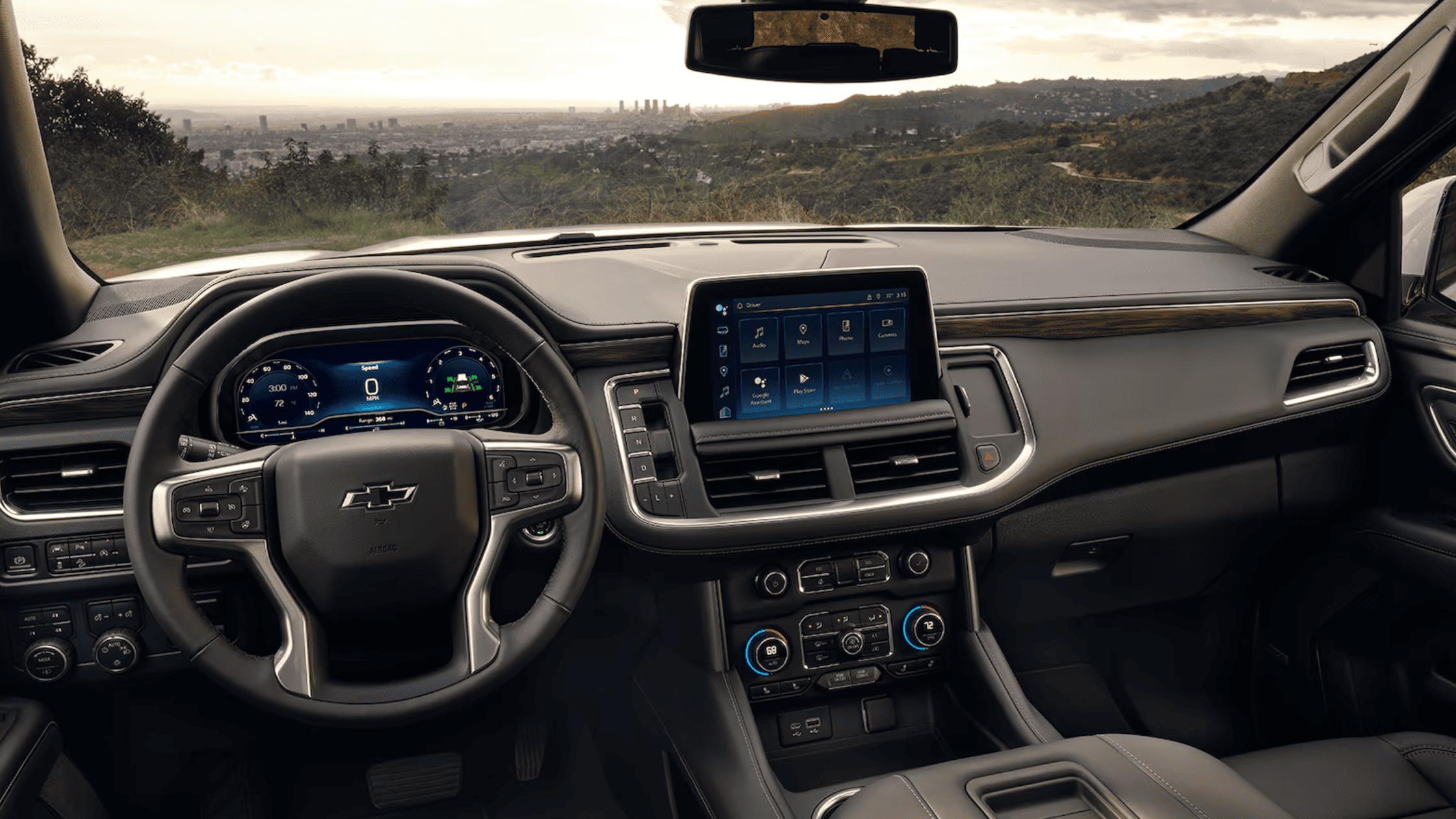 Front interior of the 2024 Chevrolet Tahoe with touchscreen and city view