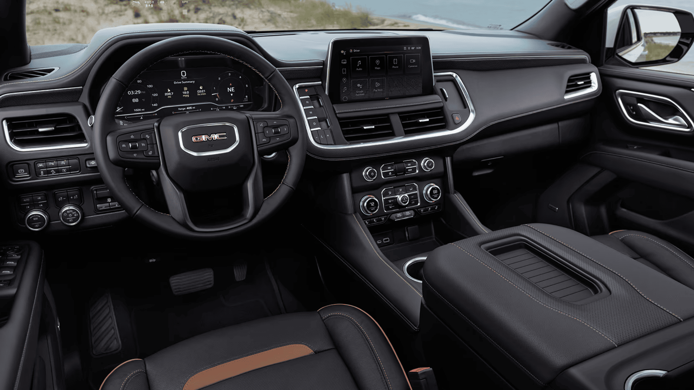 Front interior of the 2024 GMC Yukon with touchscreen and black leather accents.