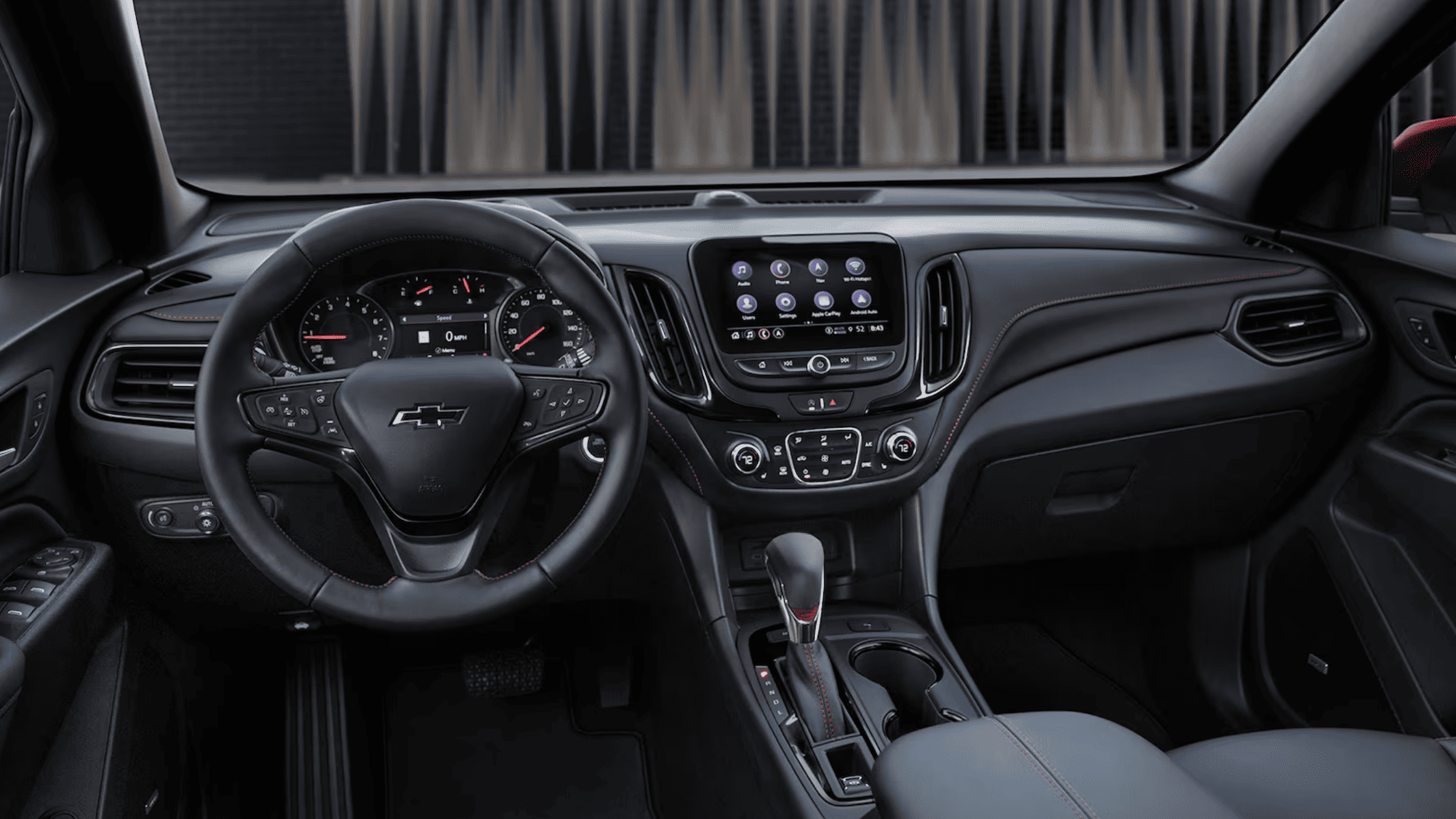 Chevrolet SUV interior showing infotainment system and steering wheel controls