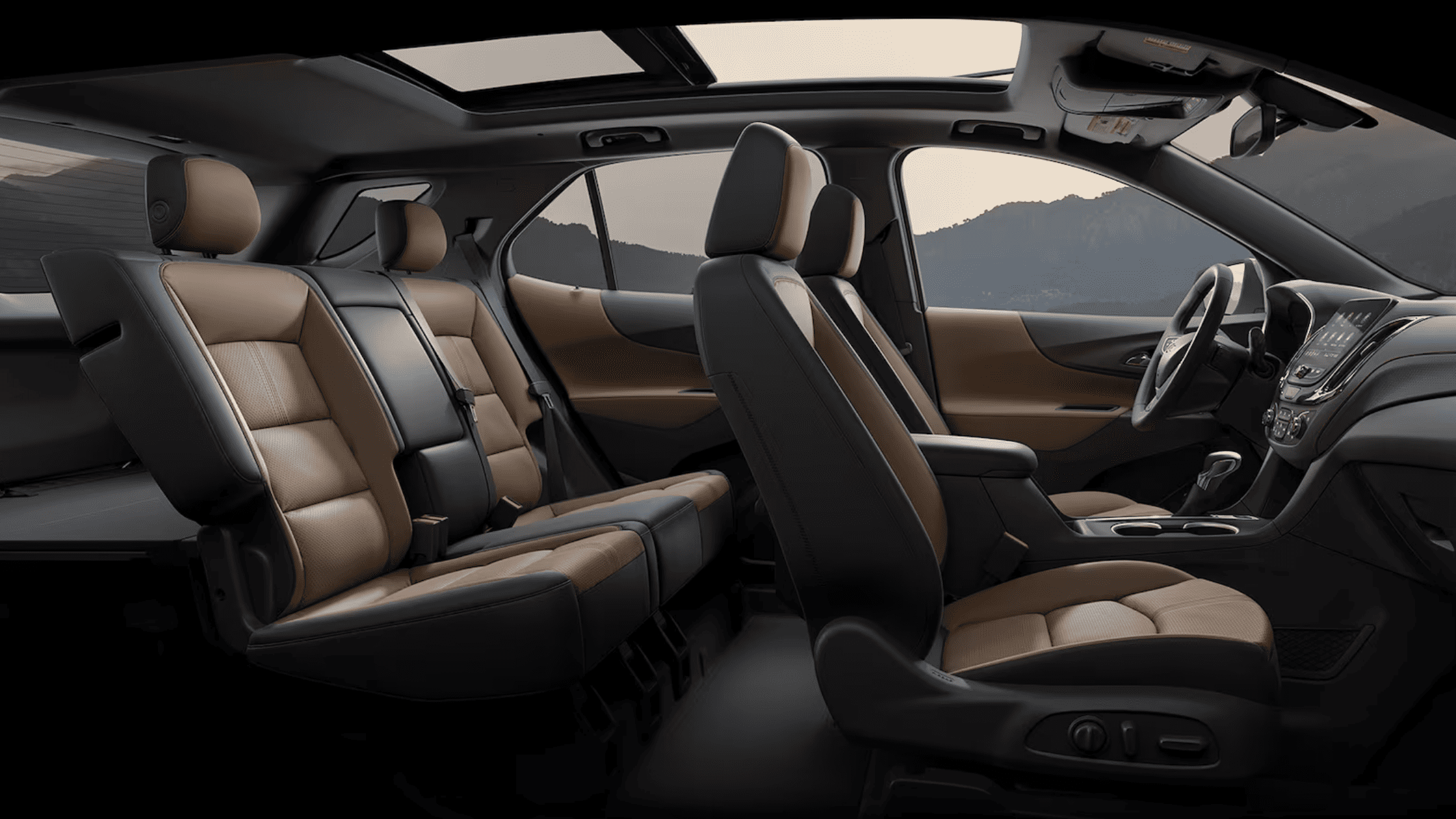 Side view of Chevrolet SUV interior with three-row tan and black leather seating