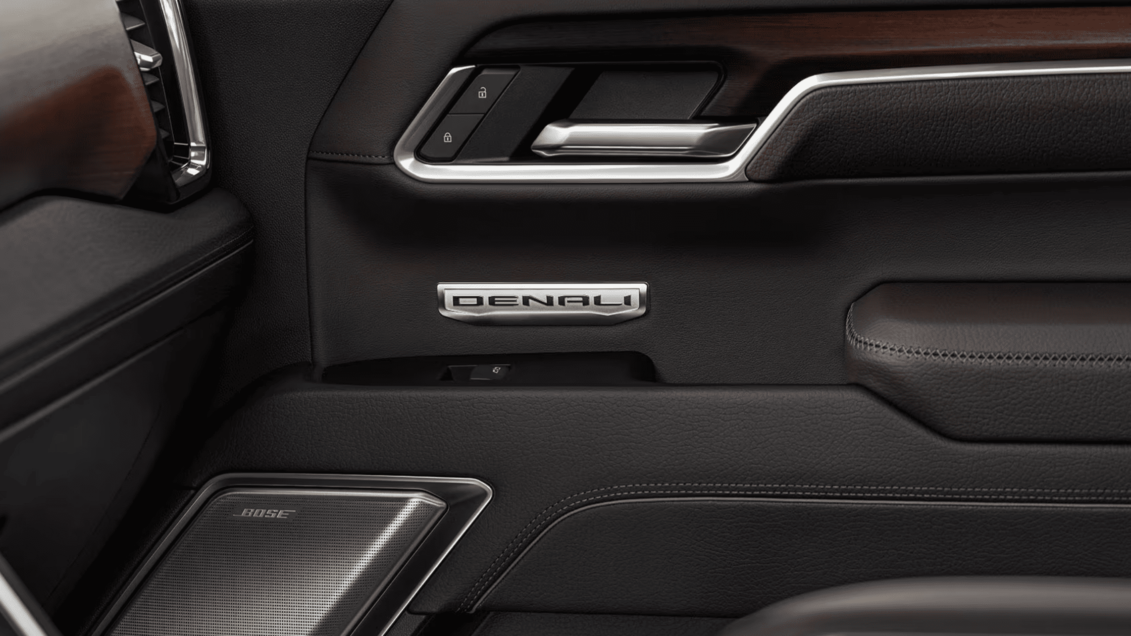 Close-up of 2025 GMC Sierra 1500 Denali door panel with Denali badge and Bose speaker