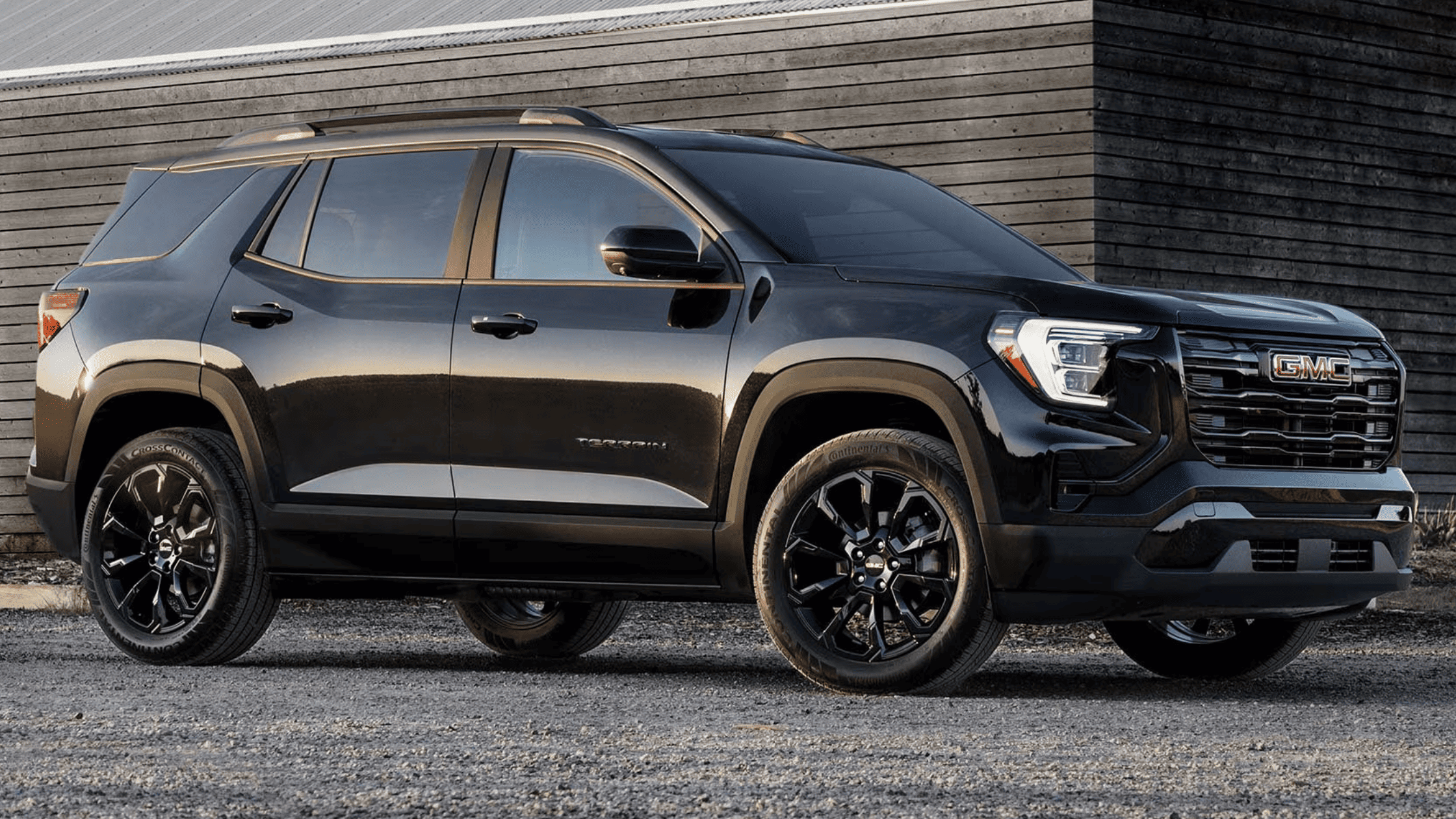Blue 2025 GMC Sierra 1500 Denali driving on mountain road near West Jefferson, NC