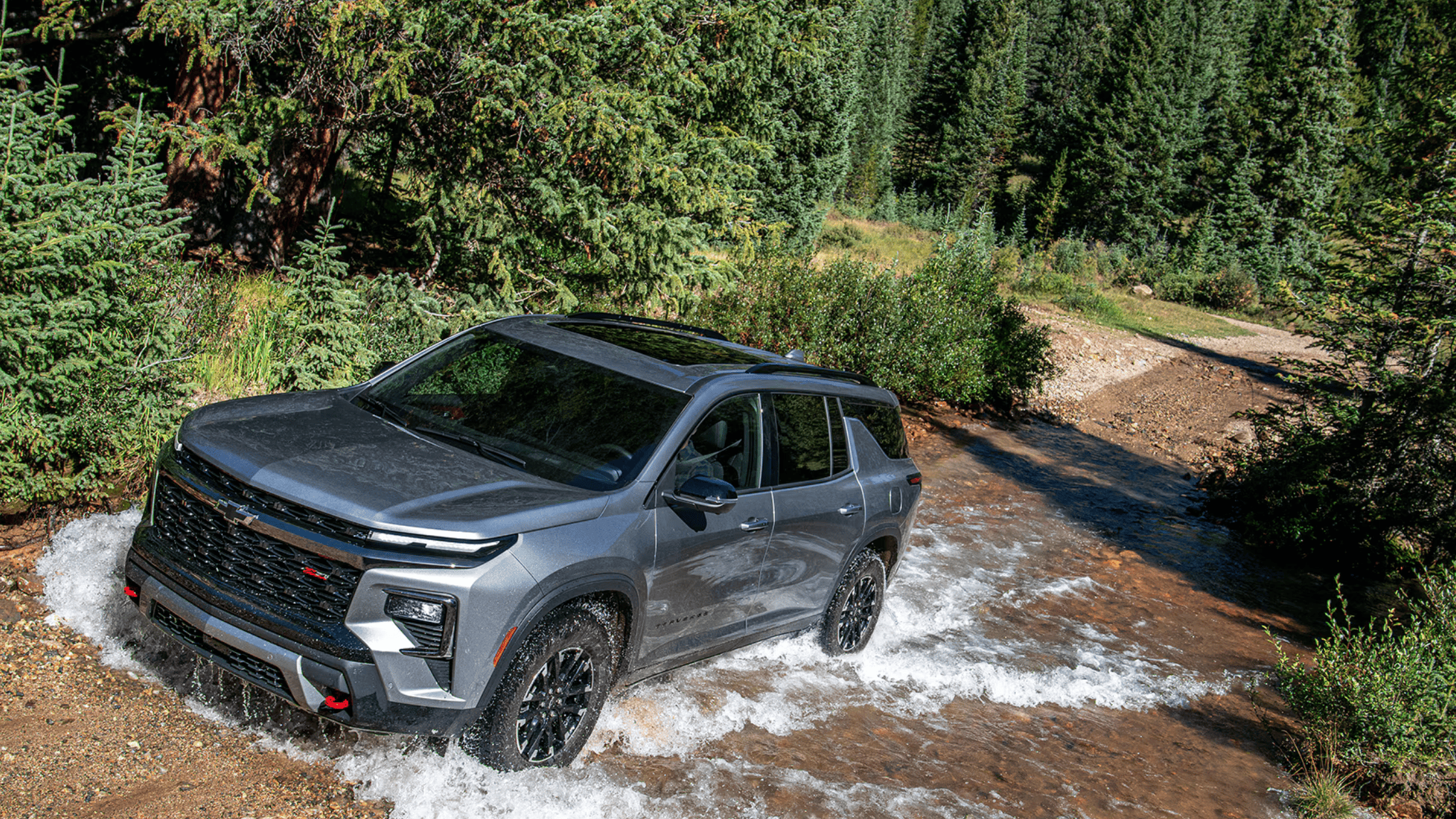 The 2025 Chevrolet Traverse parked roadside in West Jefferson, NC, highlighting its updated SUV design and bold stance.