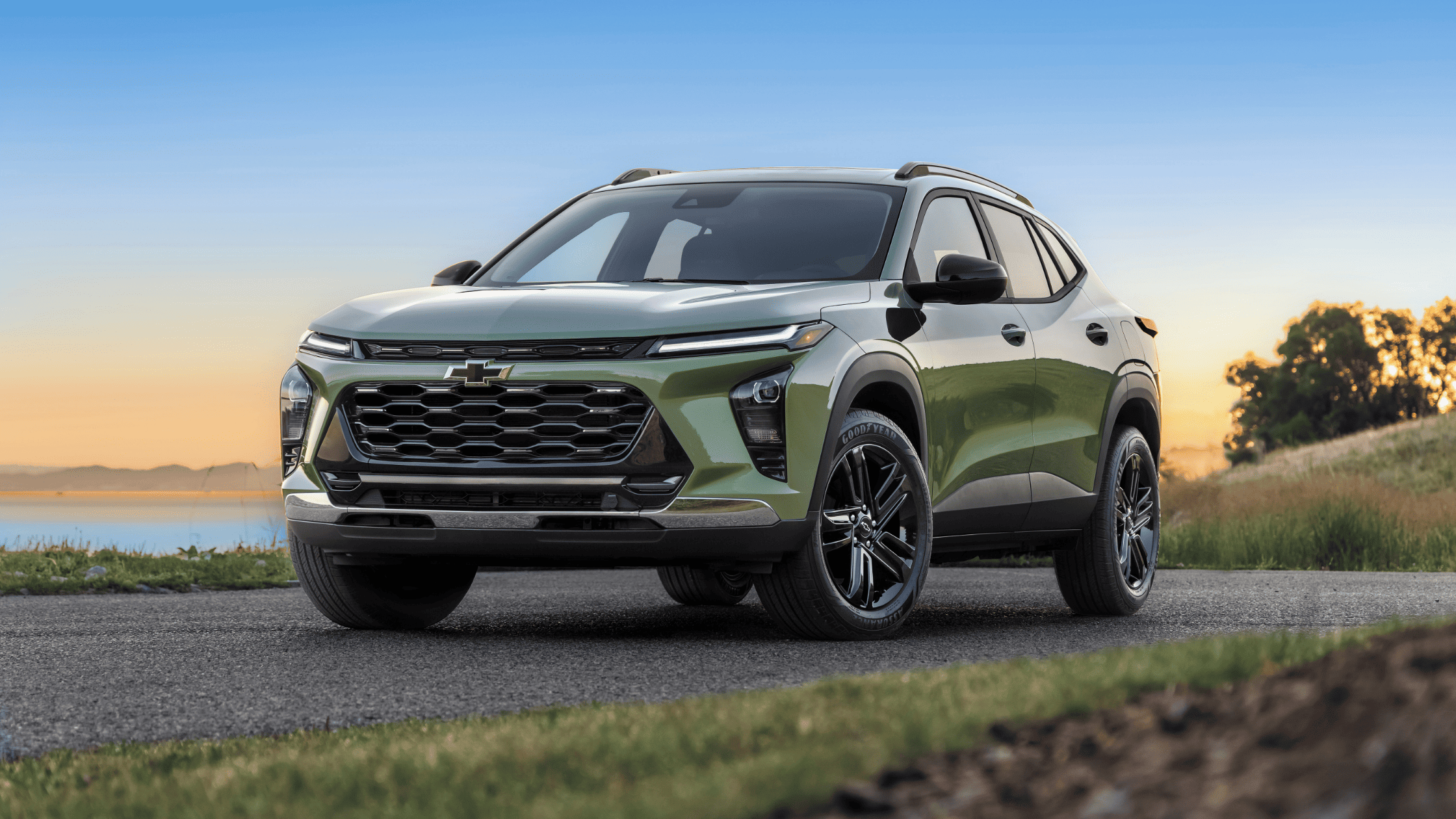 2025 Chevy Trax front view in green at sunset near lake