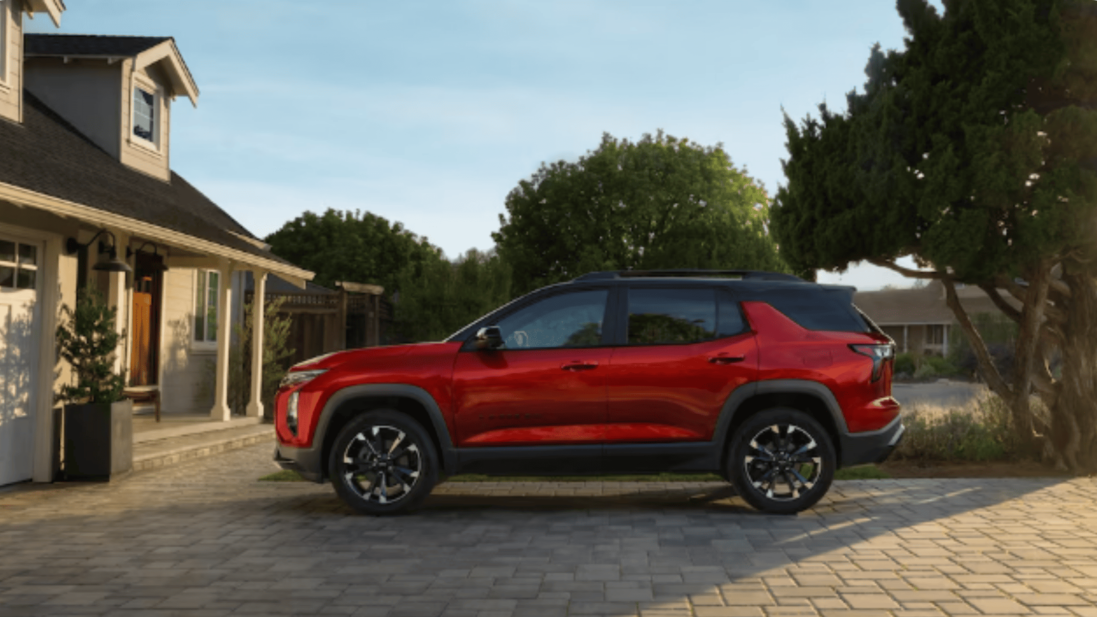 2026 Chevrolet Equinox near Morganton NC parked outside a suburban home, featuring bold red exterior and modern crossover styling.