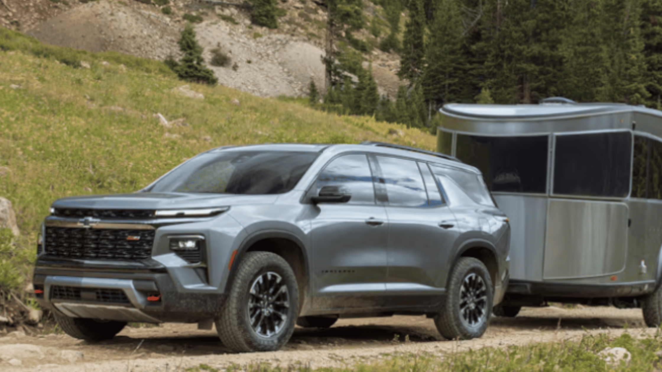 2026 Chevrolet Traverse near Morganton NC towing a trailer through the mountains, showcasing rugged capability and modern SUV design.