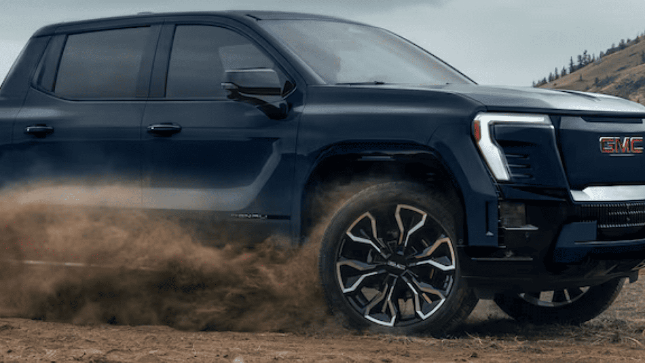 2026 GMC Sierra EV truck driving near Morganton NC with modern exterior design.