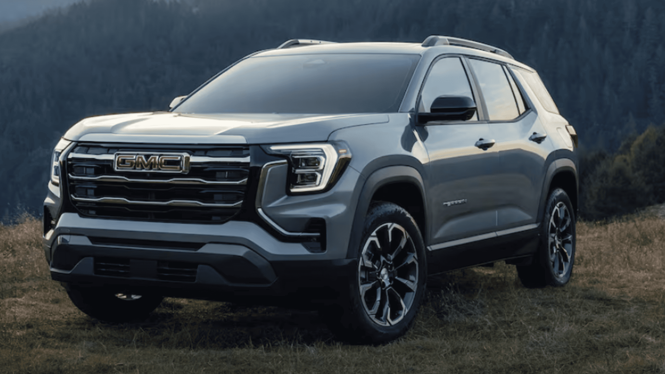 2026 GMC Terrain near Morganton, NC, parked in a scenic mountain area, showcasing its bold SUV design and off-road-ready stance.
