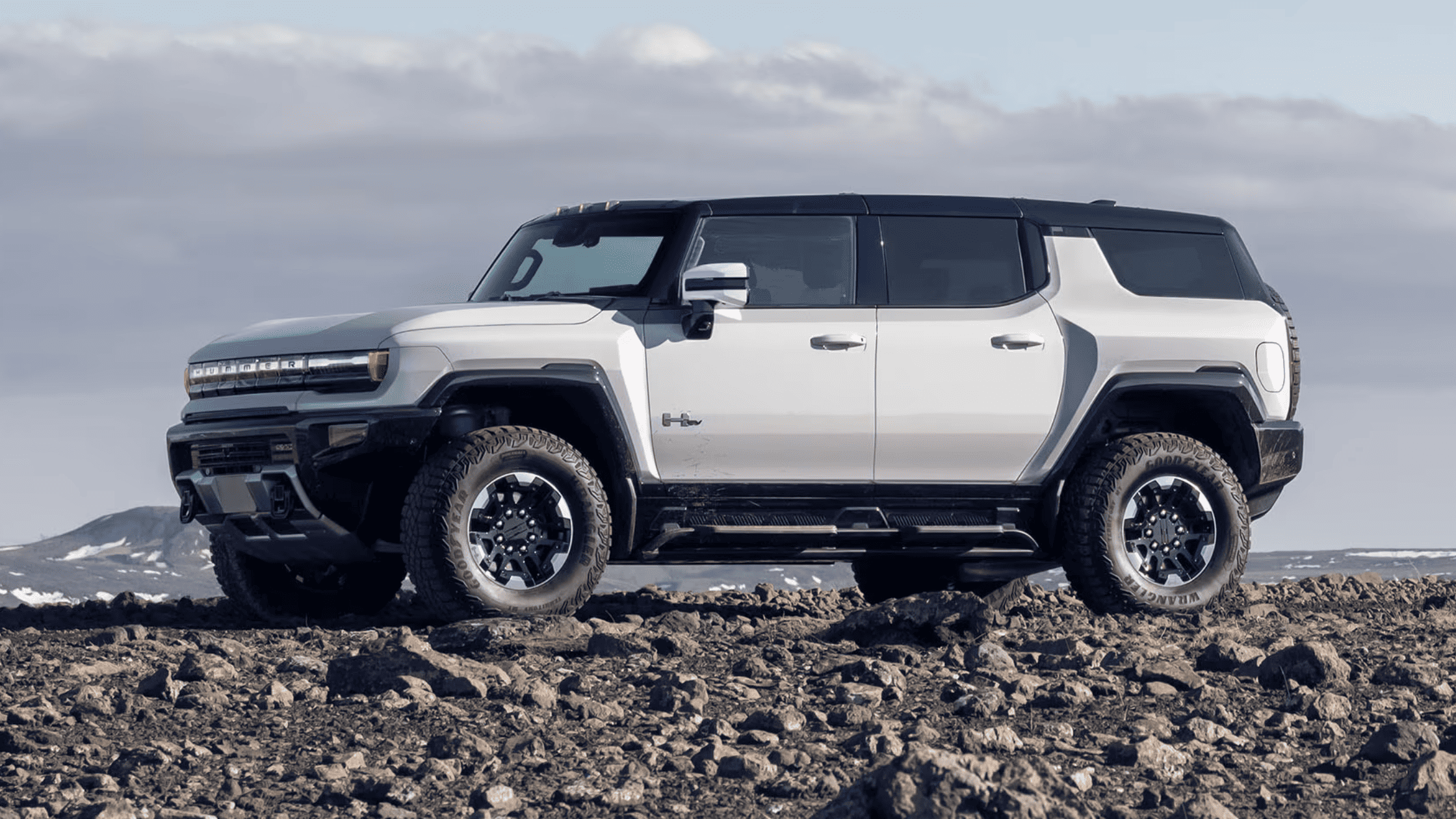 2025 GMC Hummer EV SUV off-road in Morganton NC with bold white body and rugged stance.