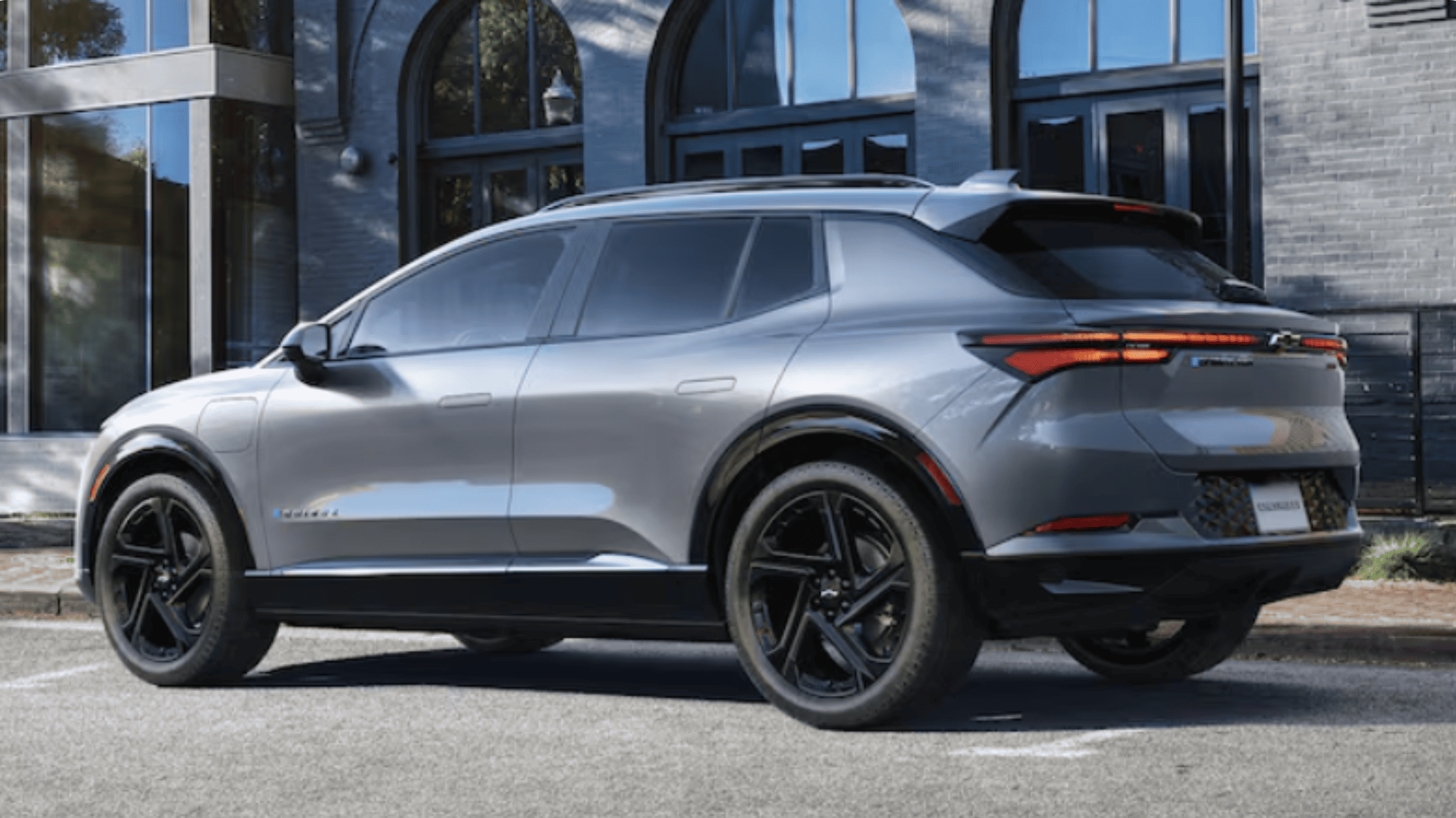 Exterior side profile of the 2026 Chevrolet Equinox EV near Morganton, NC, displaying its aerodynamic electric SUV design and black alloy wheels.