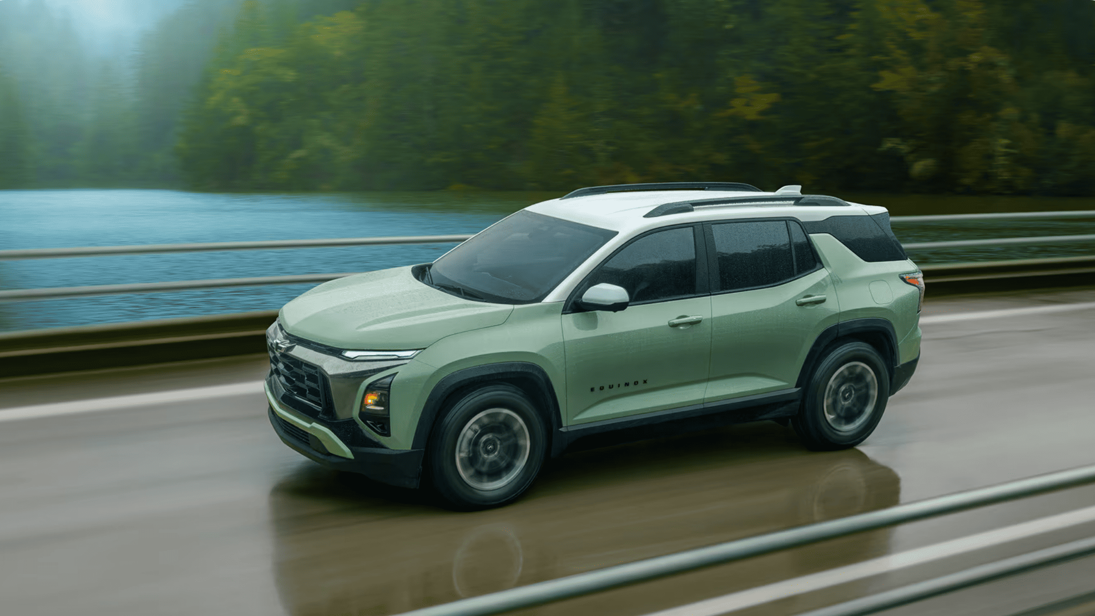 Green 2026 Chevrolet Equinox driving on a wet road near Boone, NC, highlighting performance in rainy conditions and SUV design.