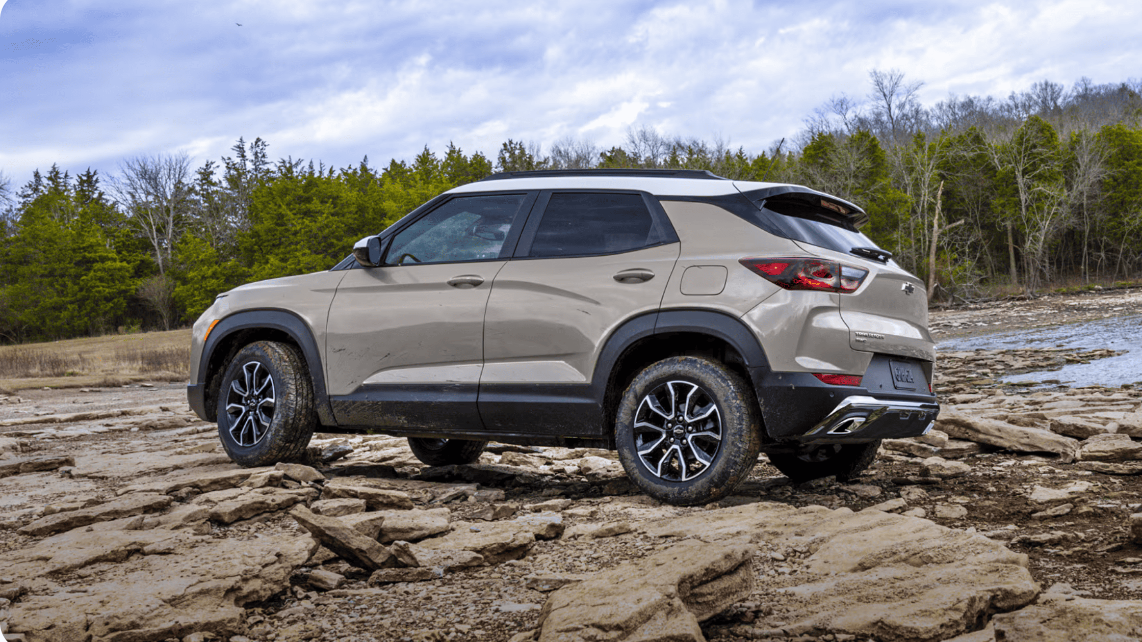 Beige 2026 Chevrolet Trailblazer parked on rocky terrain, showing exterior design, ground clearance, and off-road capability.