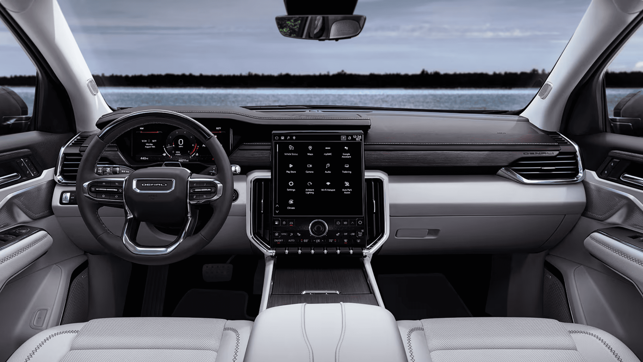 Interior dashboard of the 2026 GMC Acadia featuring large vertical touchscreen infotainment system, digital driver display, and modern cabin design.