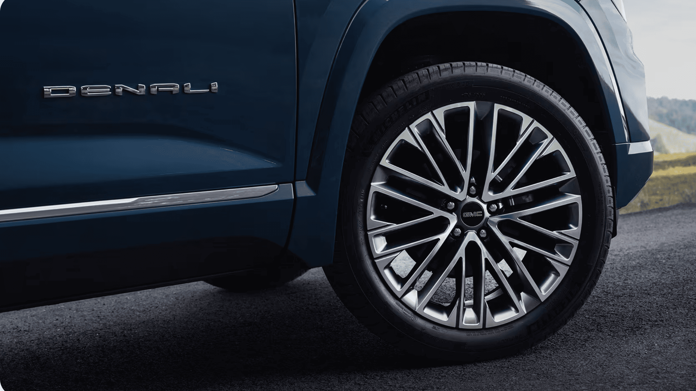 Close-up of 2026 GMC Terrain alloy wheel and tire, highlighting premium wheel design and road performance features.