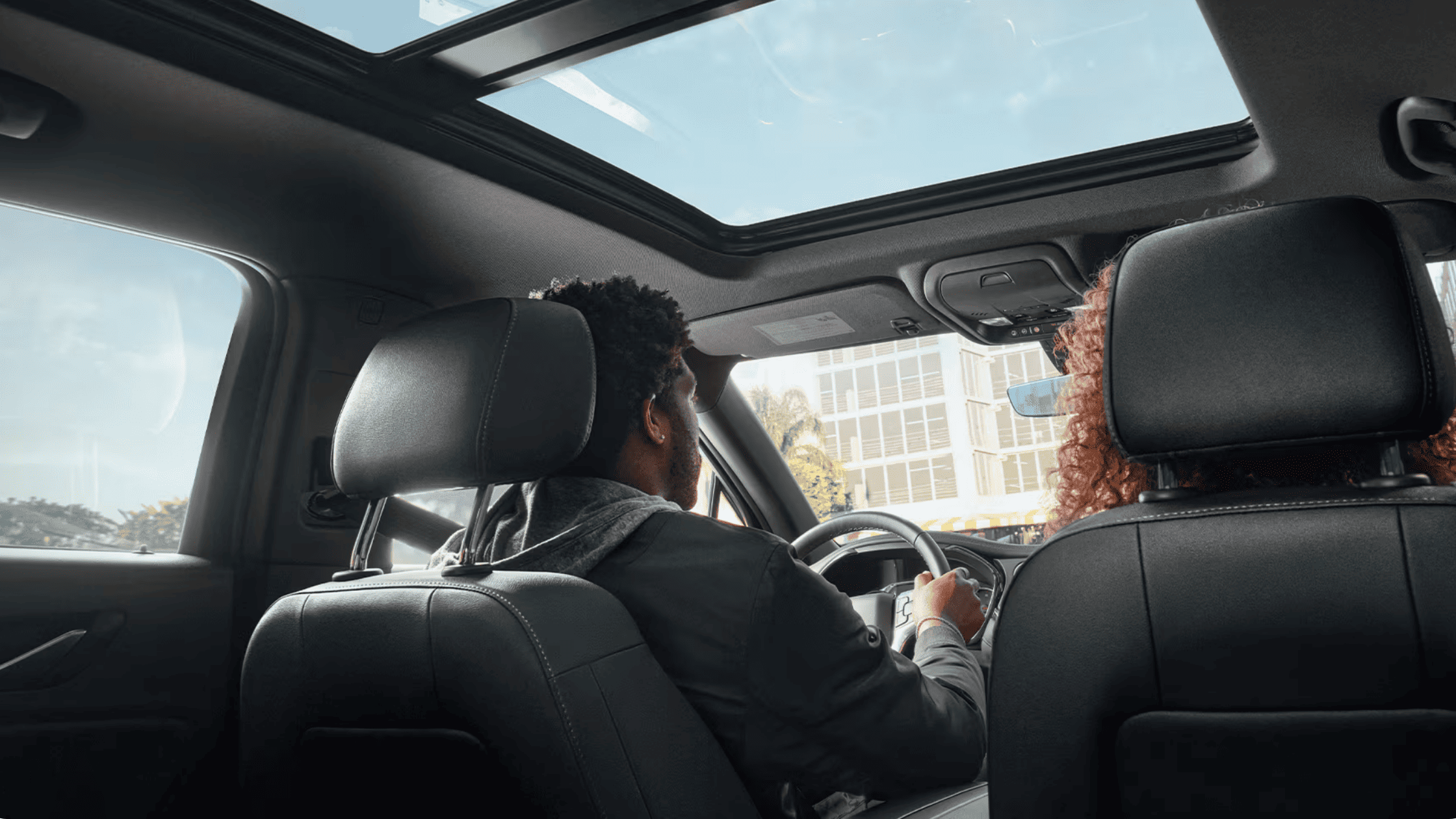 Two passengers seated inside a 2026 Chevrolet Blazer with panoramic sunroof in Boone, NC.
