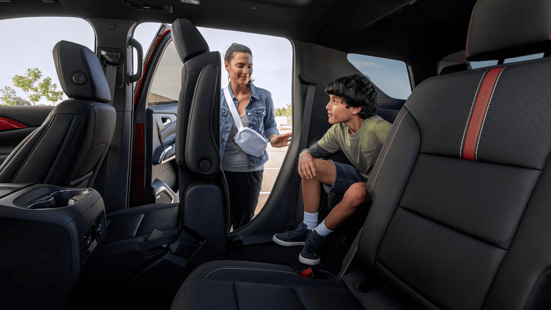 Mother and child accessing the spacious rear cabin of a 2026 Chevrolet Traverse in Boone, NC.