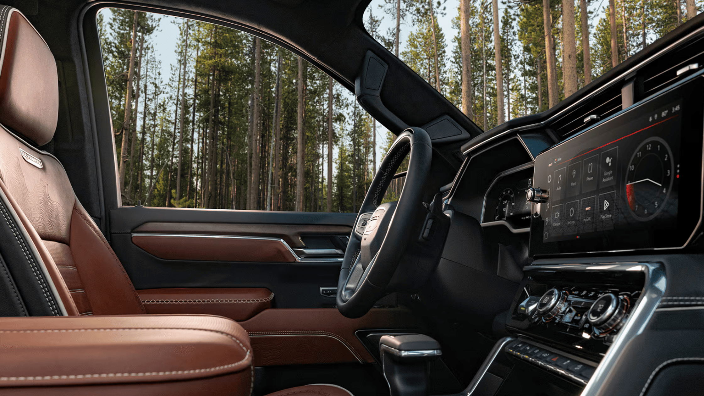 2026 GMC Sierra 1500 Denali interior with tan leather seats and large touchscreen display in Boone, NC.
