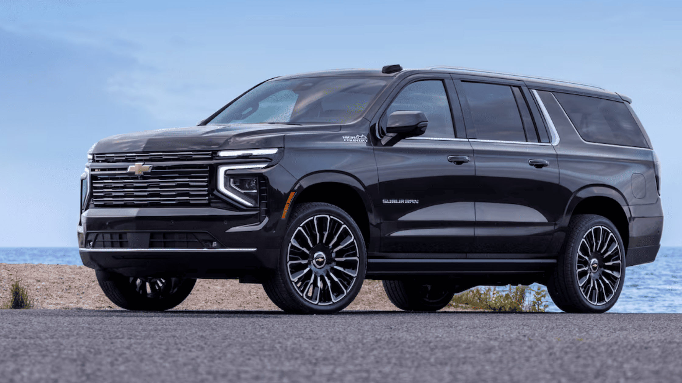 2026 Chevrolet Suburban full-size SUV photographed near Morganton, NC, emphasizing its long body design, alloy wheels, and family-friendly capability.